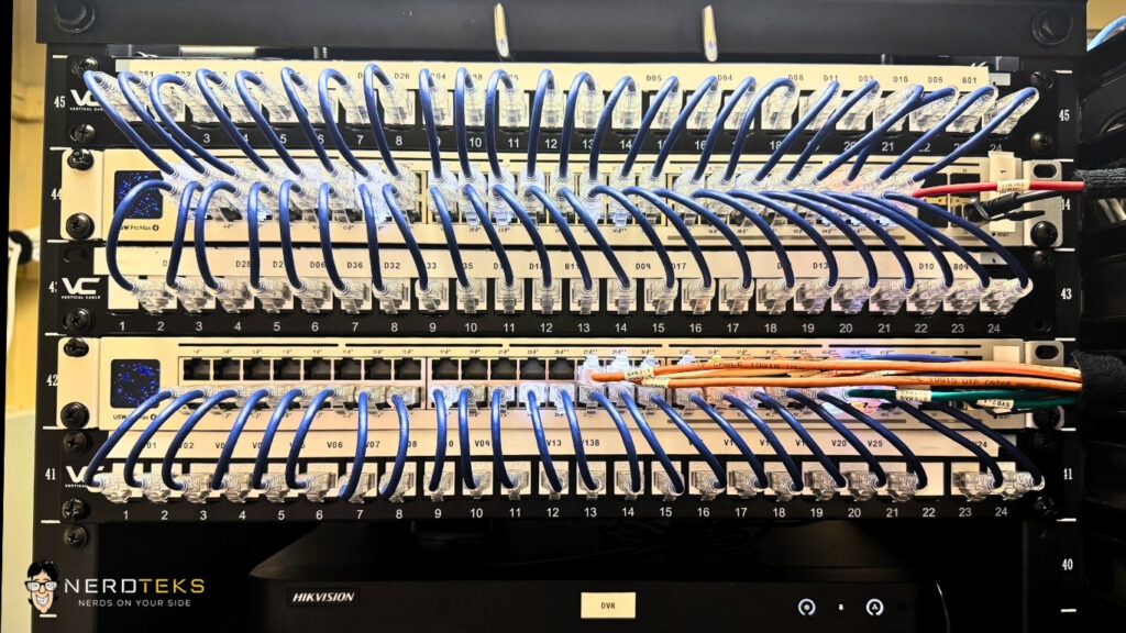 organized-network-rack-patch-panels-ethernet-cabling.jpg Organized business network rack with labeled patch panels, switches, and neatly routed Ethernet cabling.