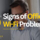 Business professional working on a laptop with the headline “5 Signs of Office Wi-Fi Problems,” highlighting common workplace connectivity issues.